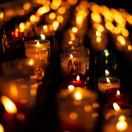 candles-being-lit-in-a-dark-room